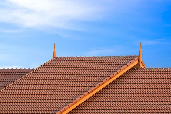Roofing contractors working on a house roof