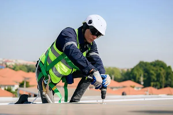 Roofing contractors working on a house roof